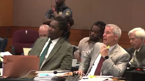 Young Thug Trying and  attorney share a  laugh during trail break..