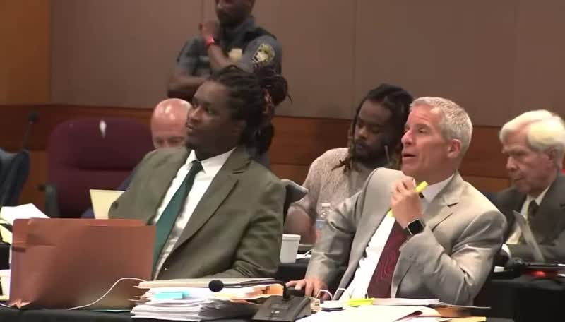 Young Thug Trying and  attorney share a  laugh during trail break..