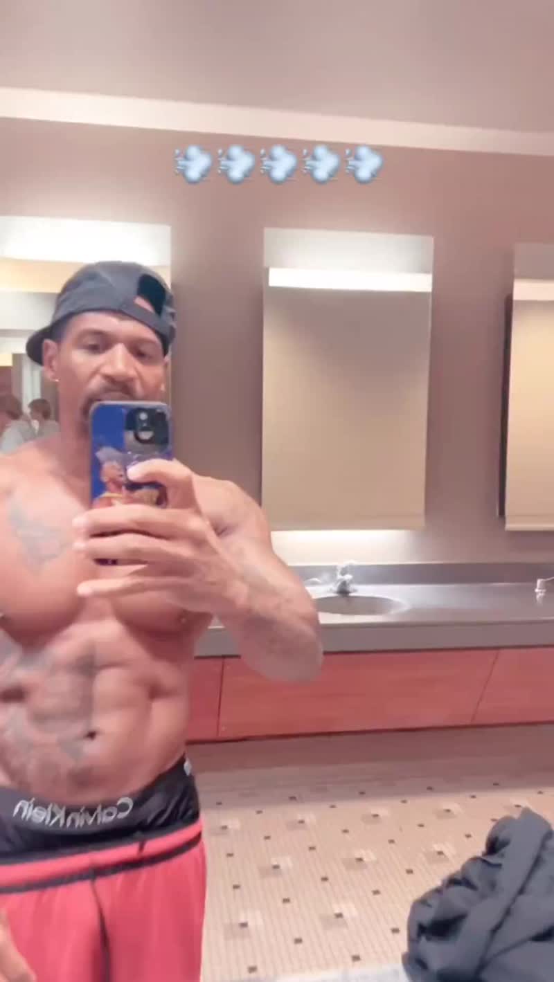 A shirtless Stevie J flexes in a public men's restroom while reacting to Diddy's son, King Combs, 50 cent diss song "Pick a Side."