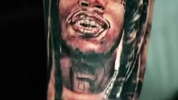Julio Foolio's mother got his face tattooed on her arm. Rest in peace