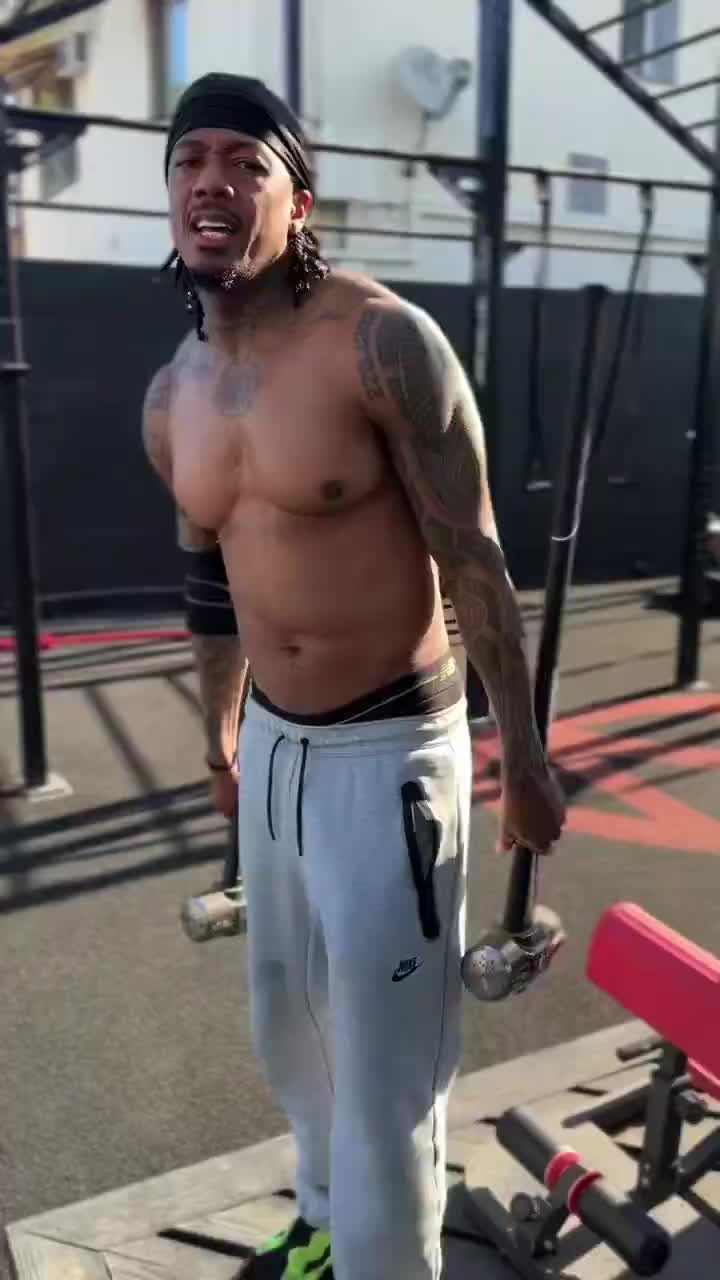 Nick cannon shows off his ski squat