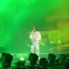 Gunna performs with a fan after he ran onto the stage