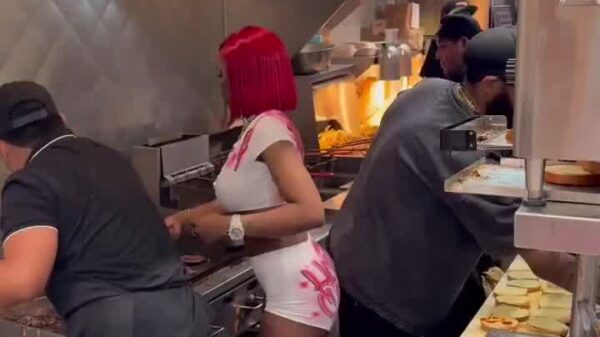 Sexyy Red cooking at Marathon Burger after performing at Rolling Loud